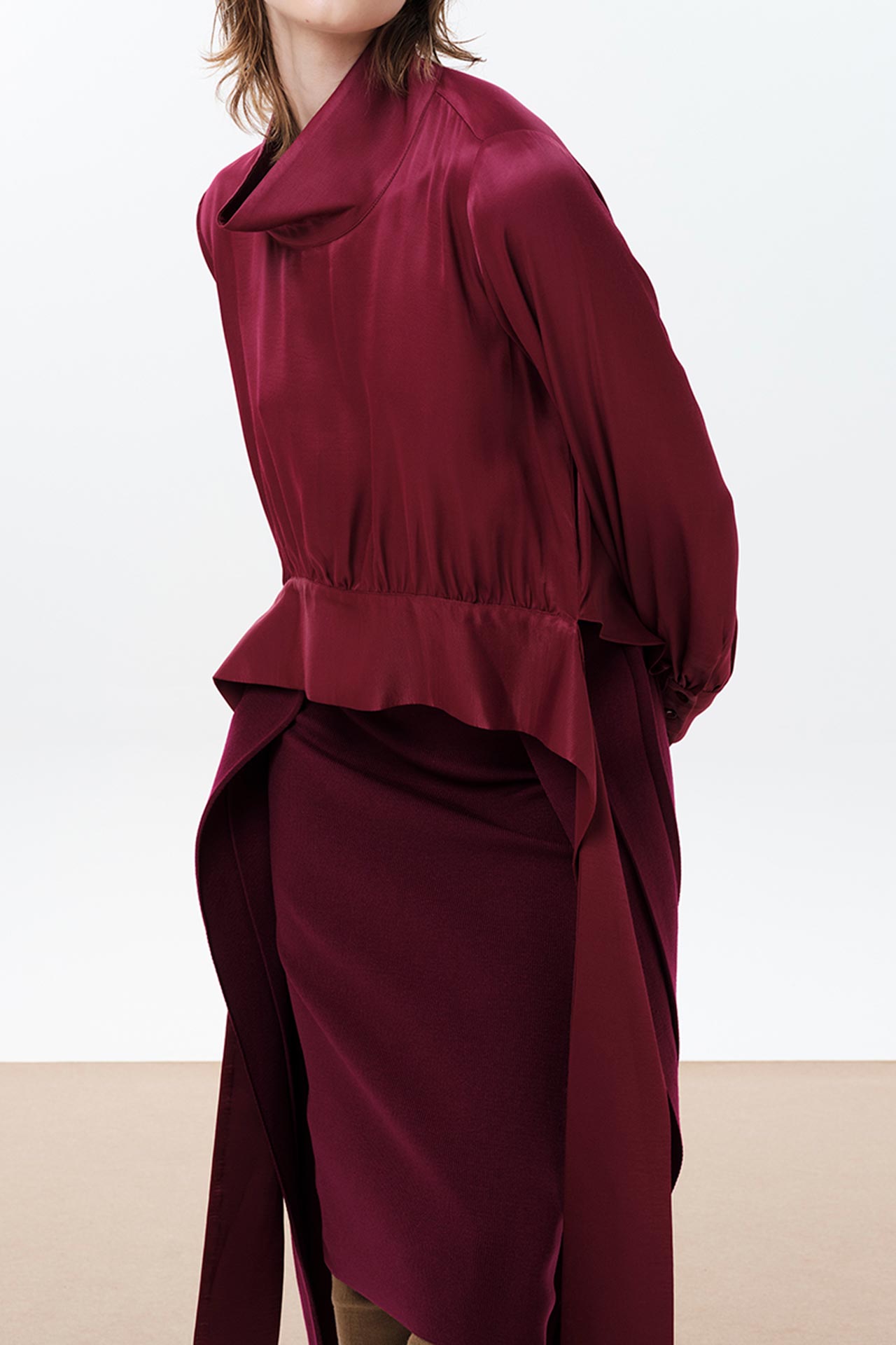 IOANNA KOURBELA IN THE FLOW RUBY RED LONG-SLEEVE TOP WITH ATTATCHED BELT DETAIL
